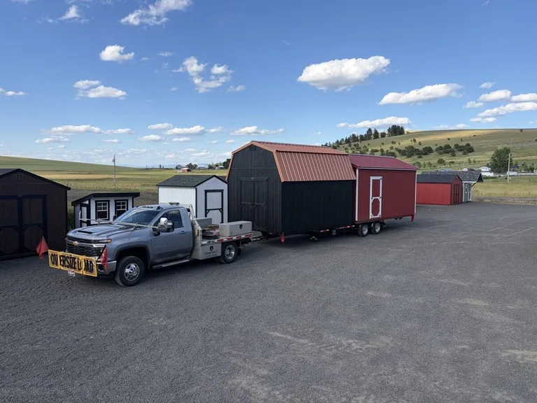 Gravel pad with drainage slope for a delivered storage shed