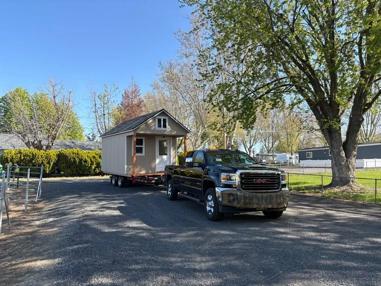 Shed being off-loaded and positioned on a prepared gravel pad