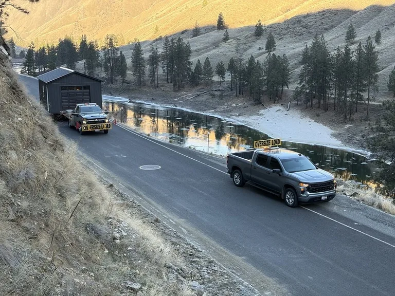 Delivery truck with barn-style shed in a rural setting