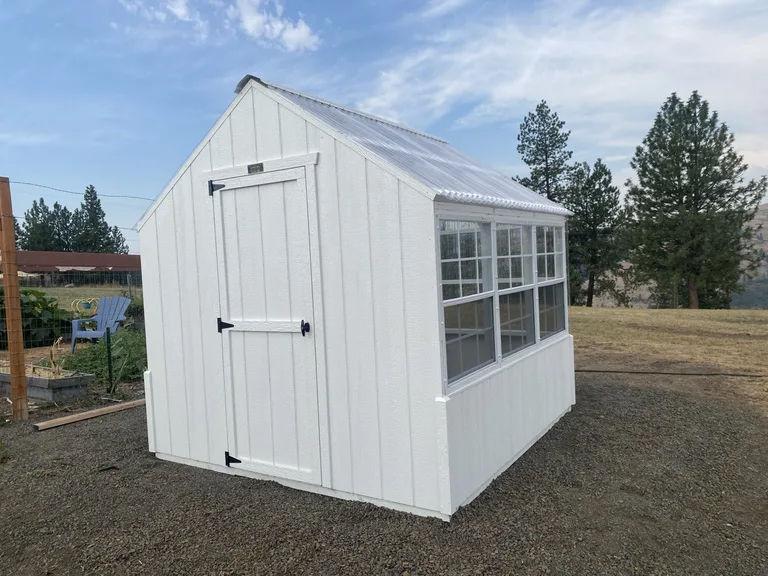 White greenhouse with operating side windows and 30-inch door