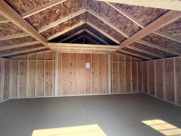 Rancher barn interior showing open framing, vaulted ceiling, and water-resistant flooring