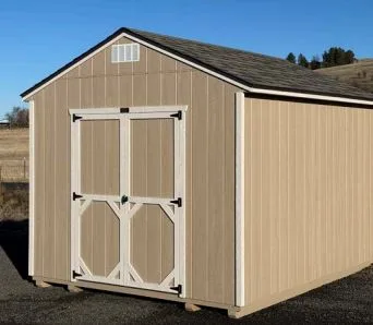 Tan utility style shed with double doors on a display lot